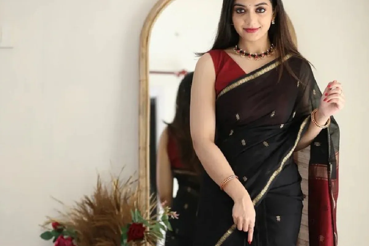 A folded Banarasi silk saree with gold zari work
